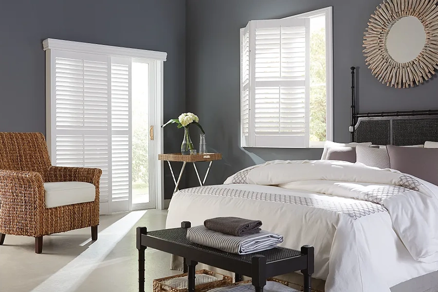 Open interior shutter letting light into a bedroom