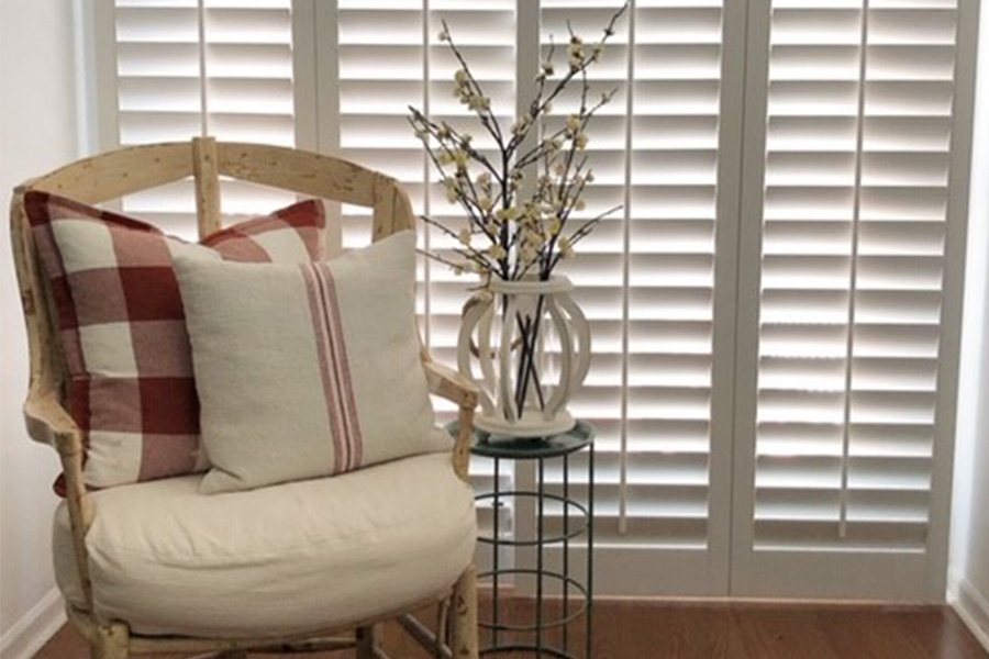 Closed white Polywood shutters on a sliding patio door.