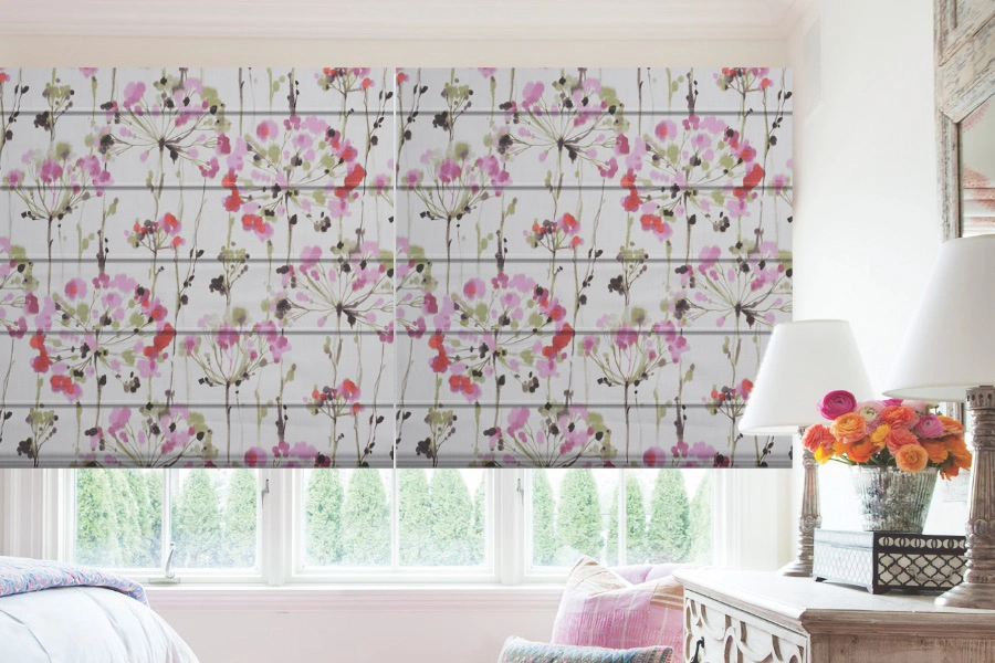 Pink floral Roman shades on casement bedroom windows