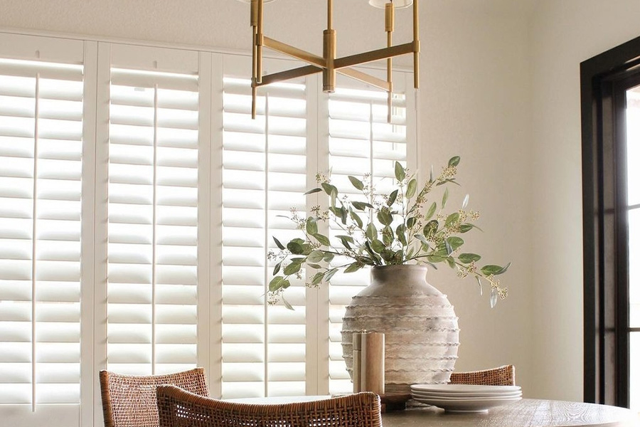 White Polywood shutters in a small corner of a breakfast nook.