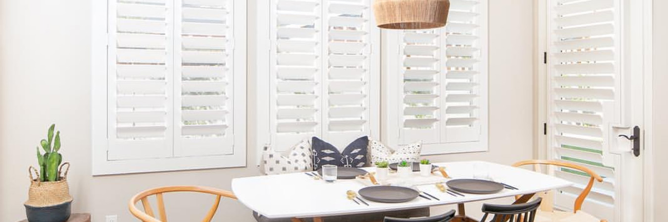 White Polywood shutters in a large dining room.