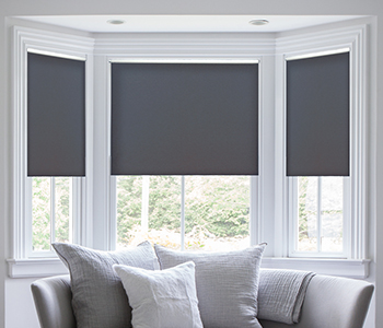 Dark gray shades within bay windows and above a window seat