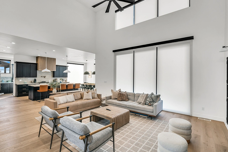 White roller shades on a sliding glass door in a contemporary living room