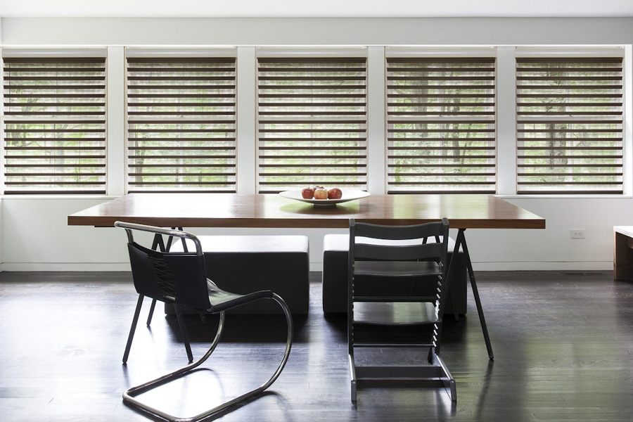 Sheer roller shades in modern dining area.