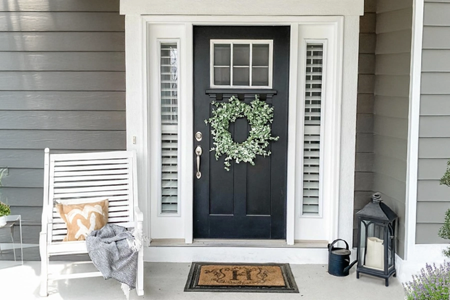 White sidelight shutters displayed on a front porch