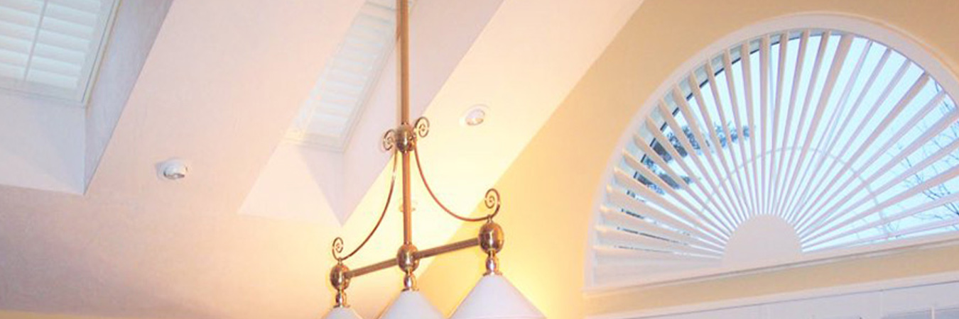 White polywood shutters in a recreational room. Skylights are shown on the ceiling.