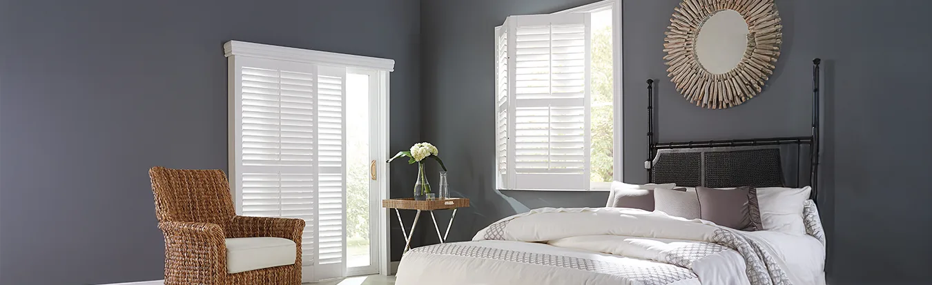 Sliding door shutters inside a large navy blue bedroom