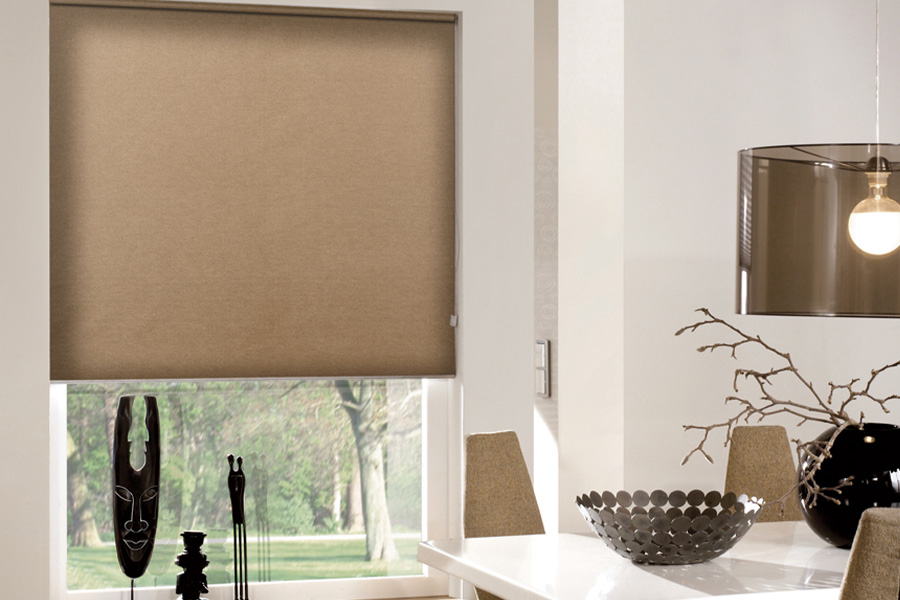  Brown roller shades in a small dining room.