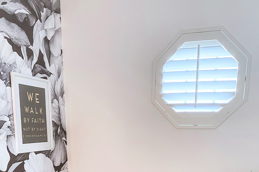 Hexagon white shutter window in a bathroom.