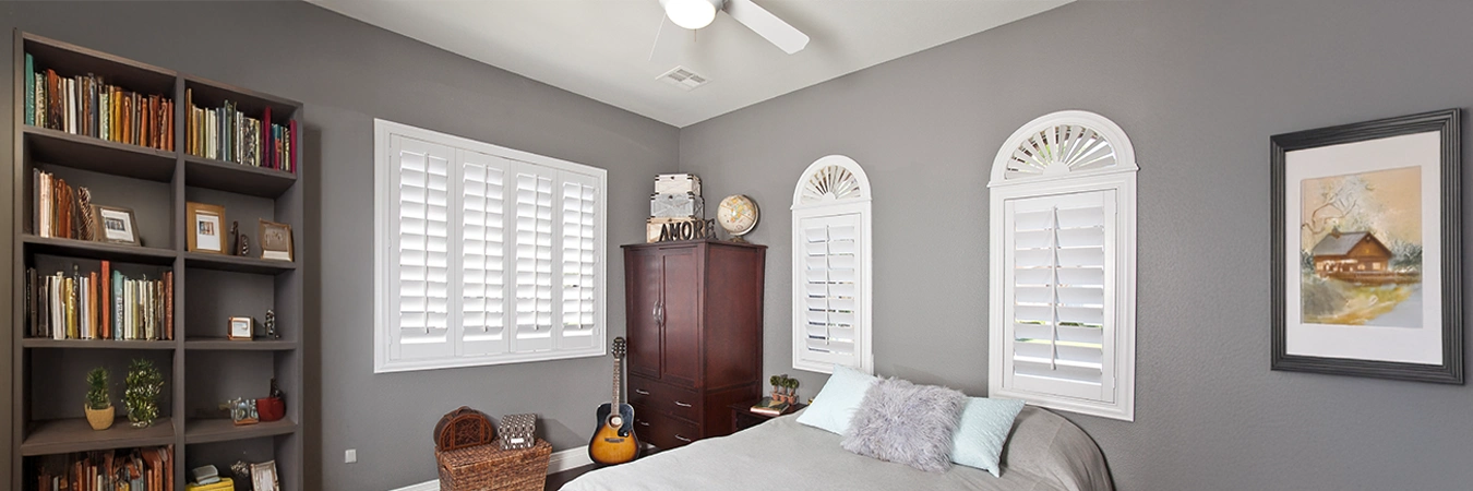 White Polywood shutters on arched bedroom windows