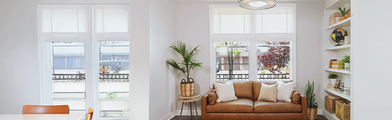 Tiered tumble shades over a couch
