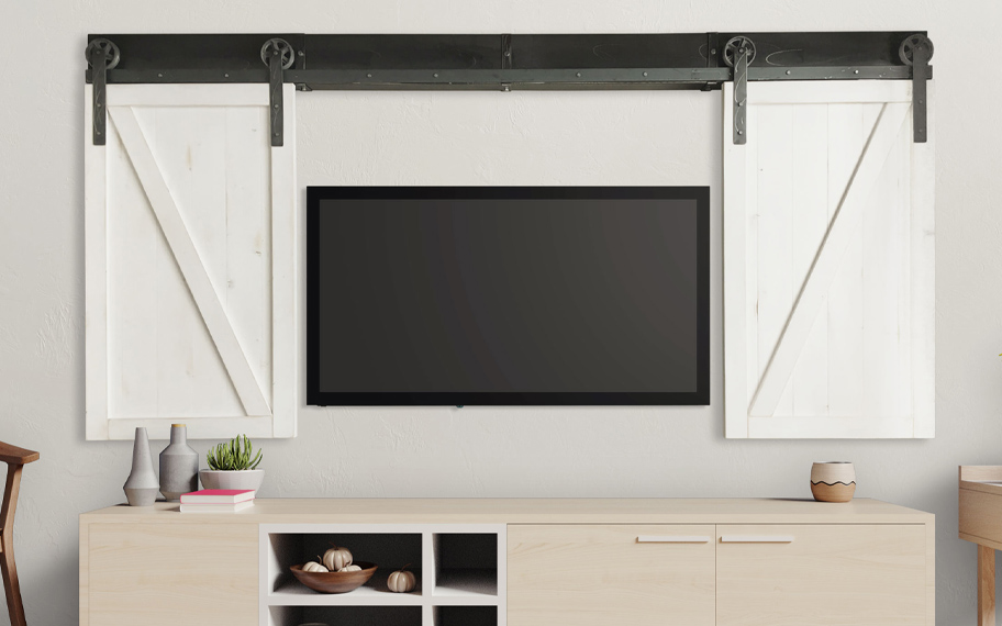 White sliding barn door shutters on each side of a flat screen tv.