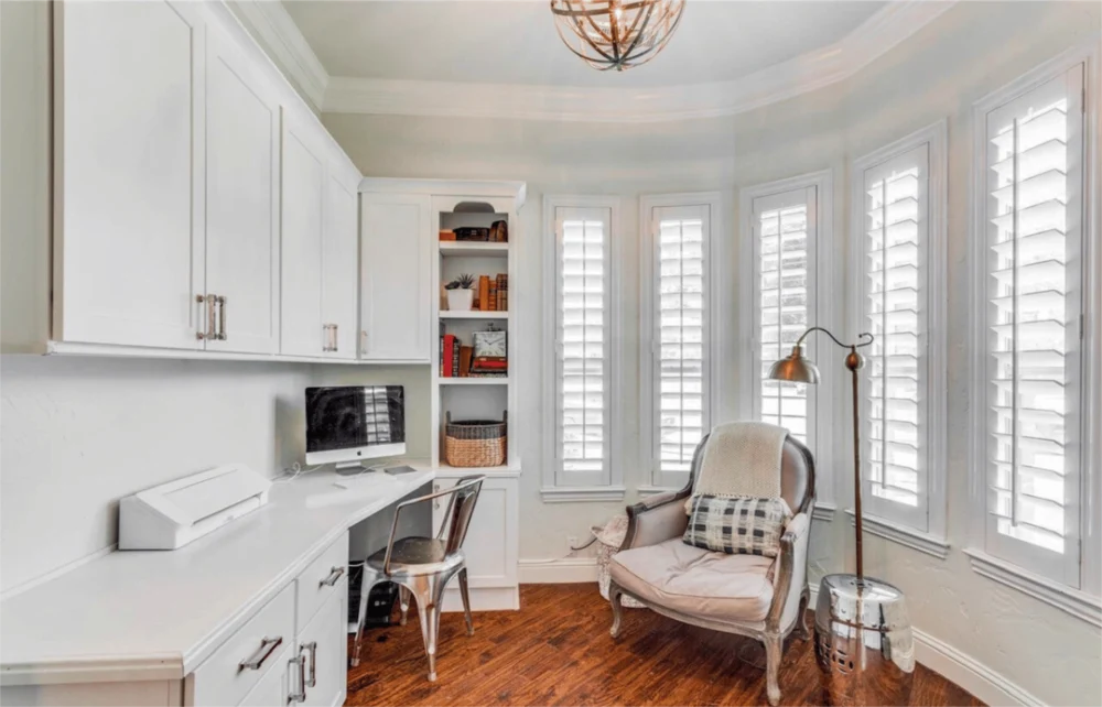 You might be able to submit your home office upgrades for a tax deduction. White polywood shutters in an ivory home office