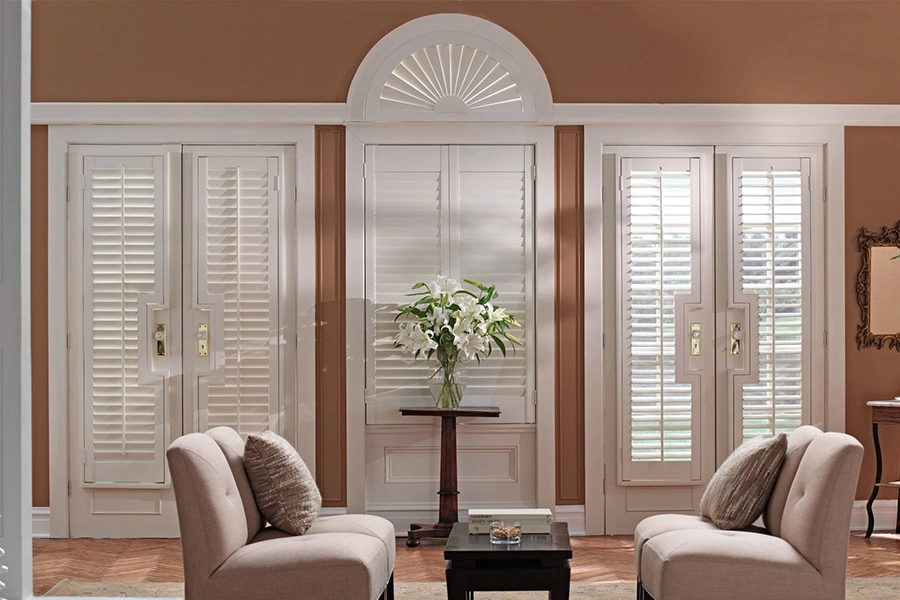 Plantation shutters on French doors leading to a back patio