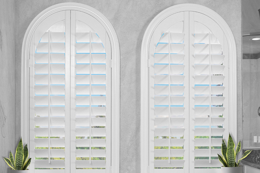 Polywood shutters are perfect for the bathroom. white Polywood shutters over large bathtub