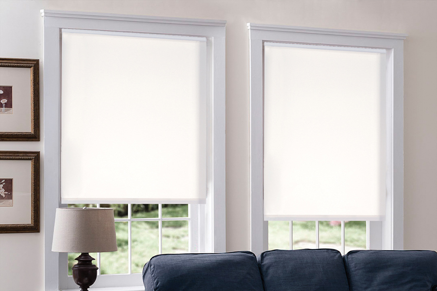 Roller shades may look simple, but they add style to your favorite family hangout. White roller shades in a casual family room with blue sofa.