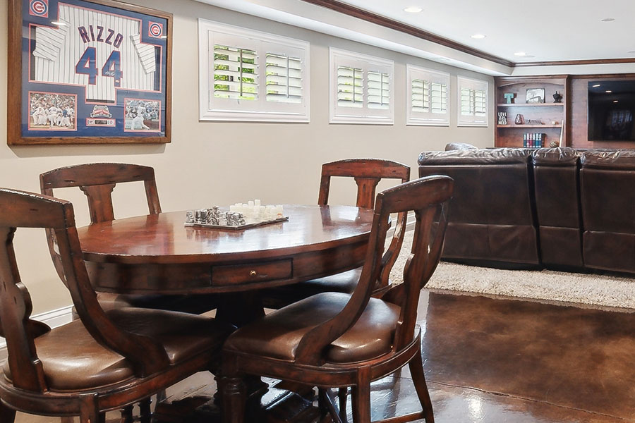 Polywood shutters add a cozy touch to your basement entertainment room. Polywood shutters on small windows in a finished basement