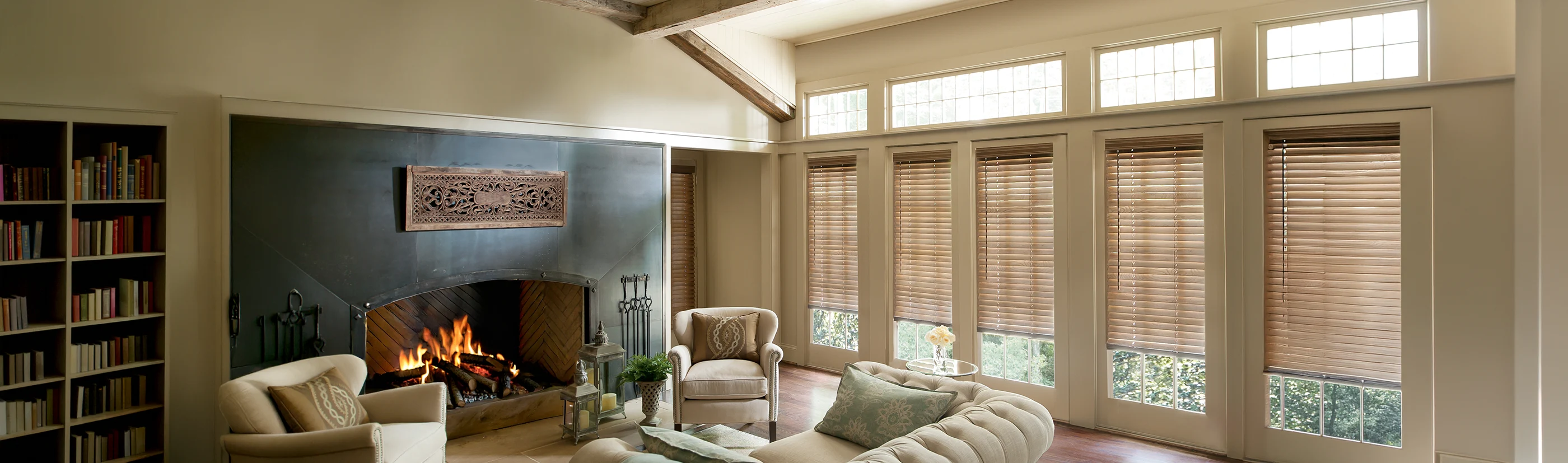 wood blinds in a large rustic decorated living room with a fire place
