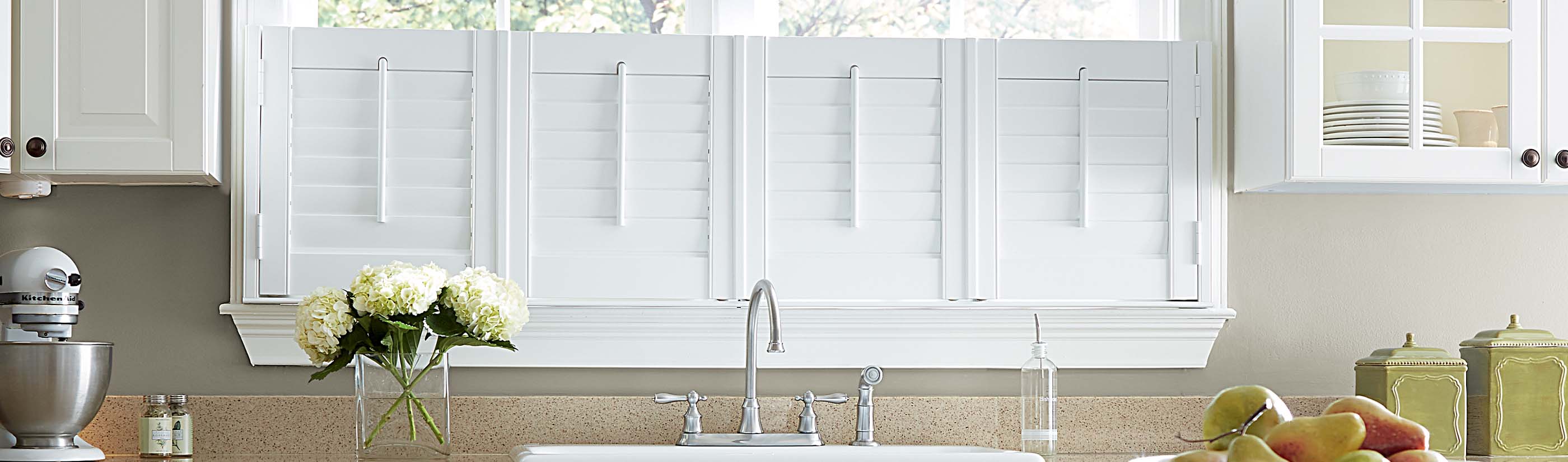 white cafe shutters above a kitchen sink 