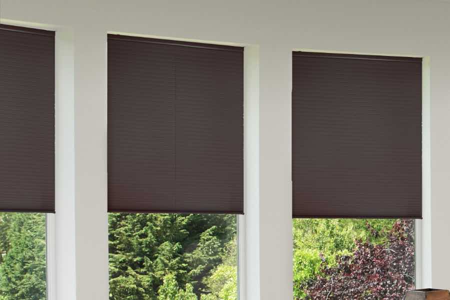 You can see the quality of our products yourself when you have an in-home consultation with Sunburst Shutters. Brown shades on living room windows