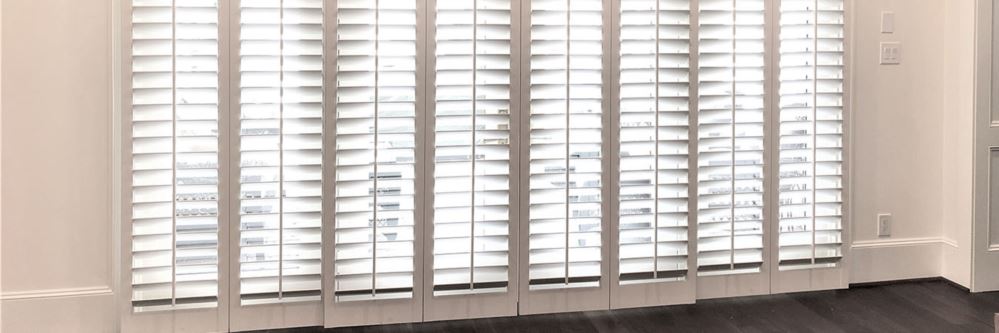 Bypass Polywood shutters on a large sliding glass door