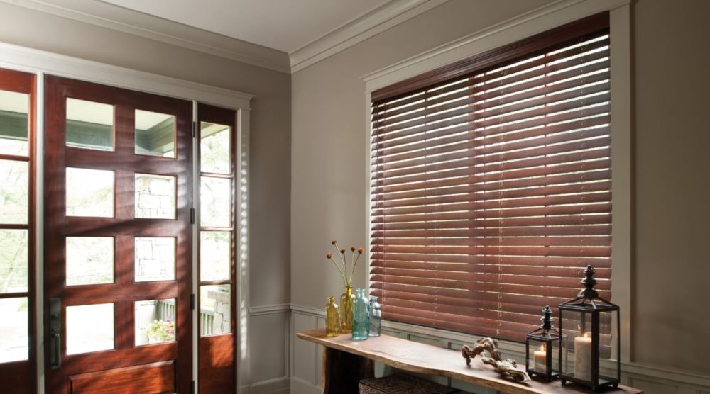 Blinds can be angled to bring in additional light. Dark Polywood® blinds in an entryway.
