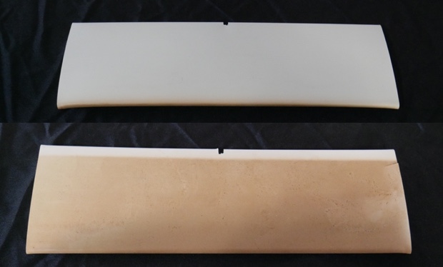 A cheap, knock-off vinyl shutter is scorched by the sun. Discolored shutter louvers