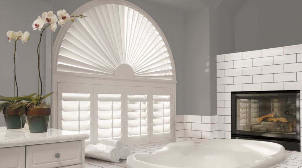 Plantation shutters look beautiful in every room of a vacation rental home. Arched plantation shutters over a tub.