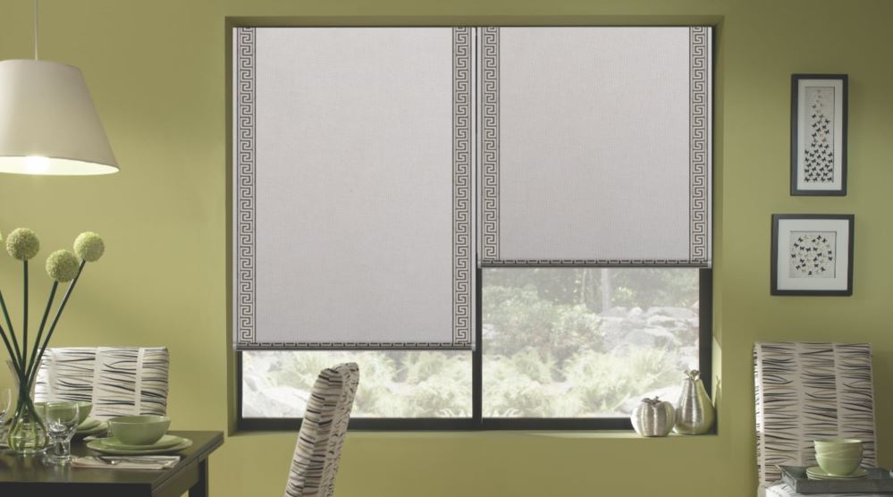 Roller shades are available in a variety of materials and colors. Roller shades covering a large window.