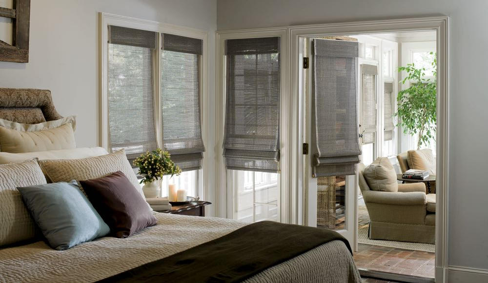 Woven shades are made of natural materials and provide a great deal of privacy. grey woven shades in bedroom windows