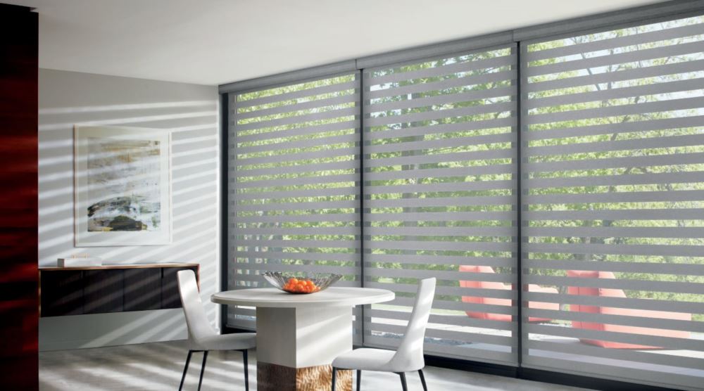 Zebra shades come with multiple setting that allow you to control light. Zebra shades in a dining room
