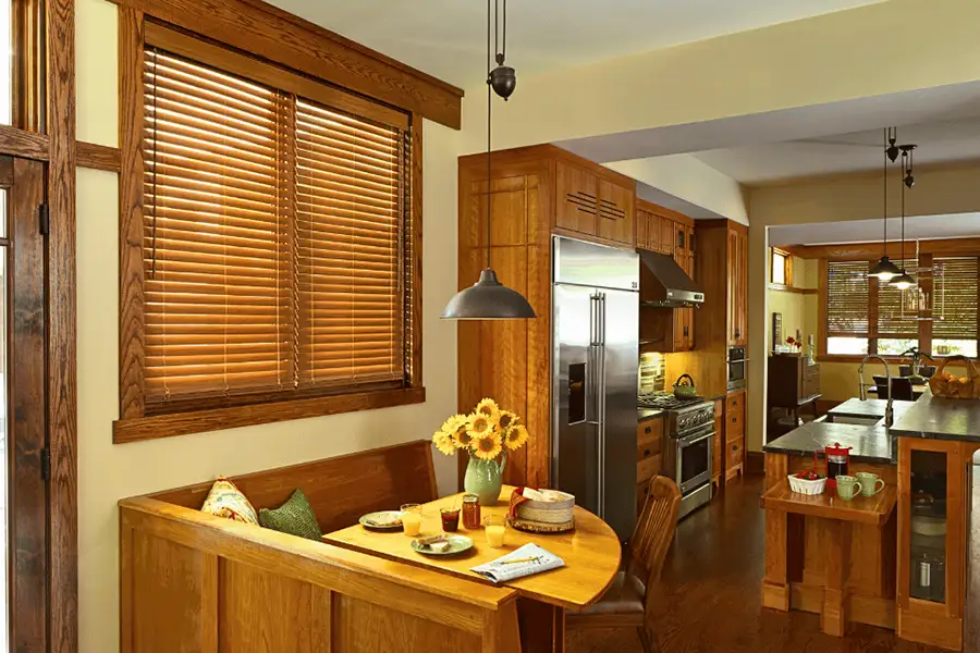 Sunburst Shutters' consultants can make sure your faux-wood blinds match your home elements, like kitchen cabinets. Faux wood window blinds matching the wood cabinets of a kitchen