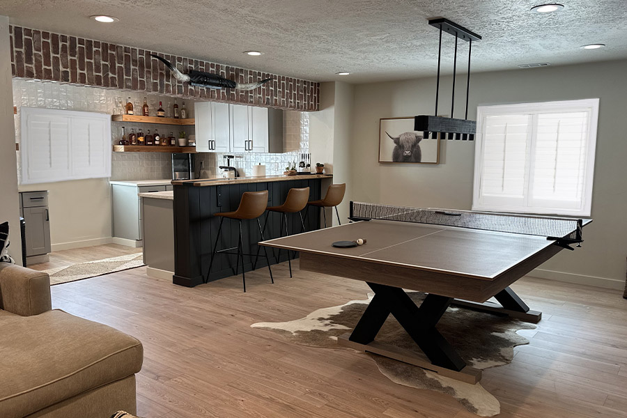 Polywood shutters add a cozy touch to your basement entertainment room.