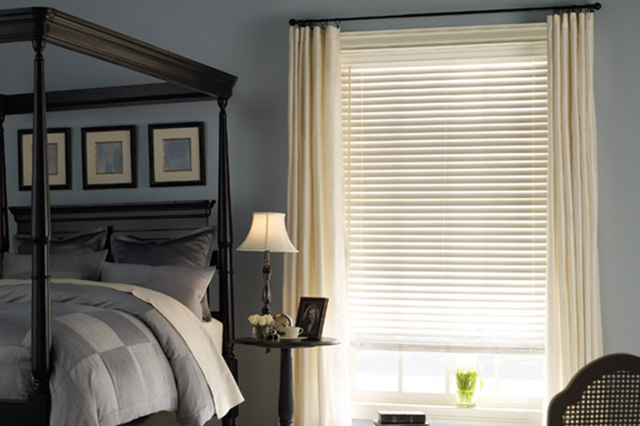 No matter the color of your walls, white window blinds are the perfect accent!  White window blinds with white curtains on a bedroom window