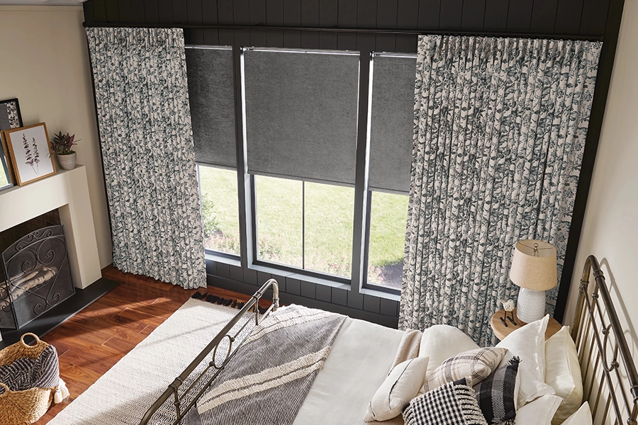 High-end curtains offer the best combination of light blocking and privacy. white and blue floral drapes inside a large bedroom
