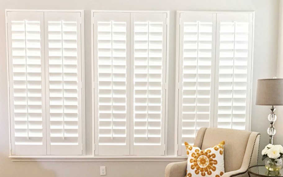 Polywood shutters provide both natural light and privacy. White polywood shutters in a living room.