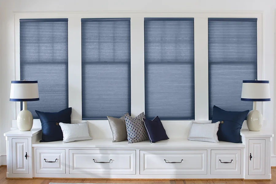 Insulate your windows and enhance your decor with colorful cellular shades Blue cellular window shades on four windows above a window seat