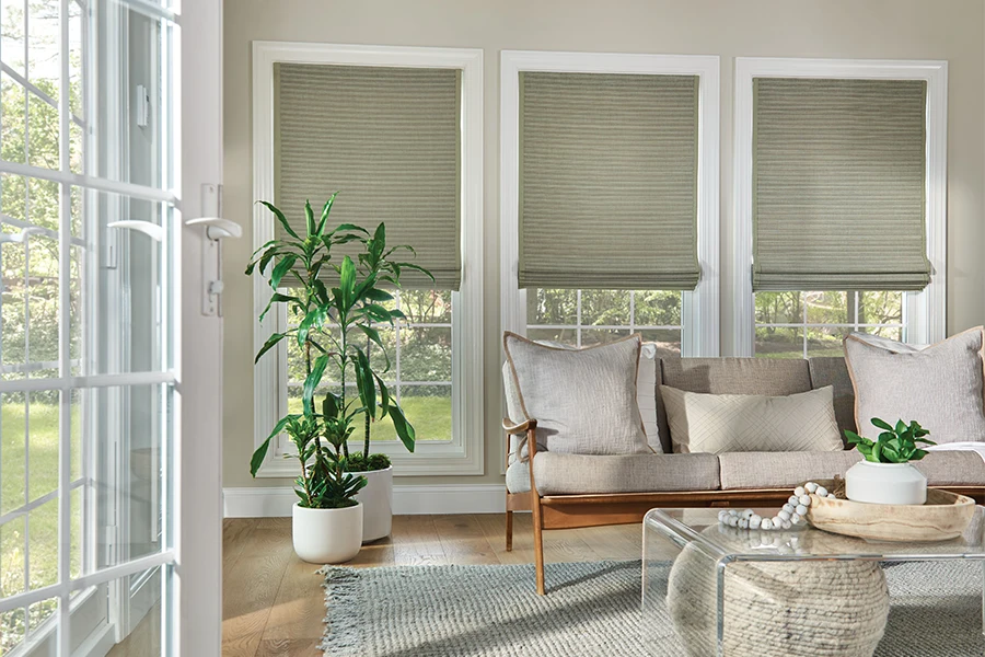 Gray motorized woven shades on living room windows