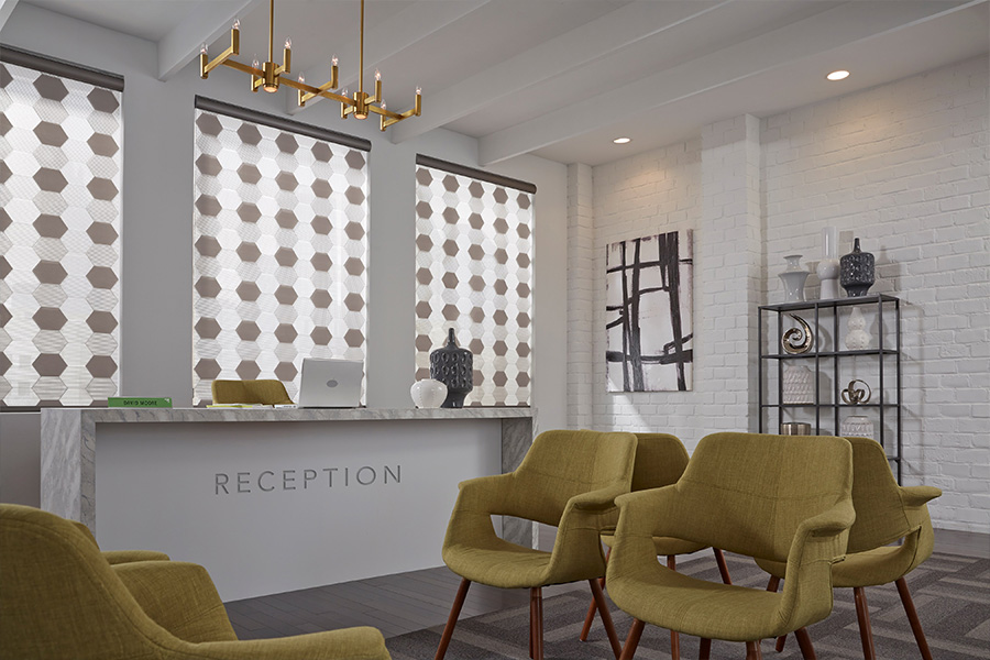 Roller shades display professionalism and character in . Hexagon style shades in a reception front desk area