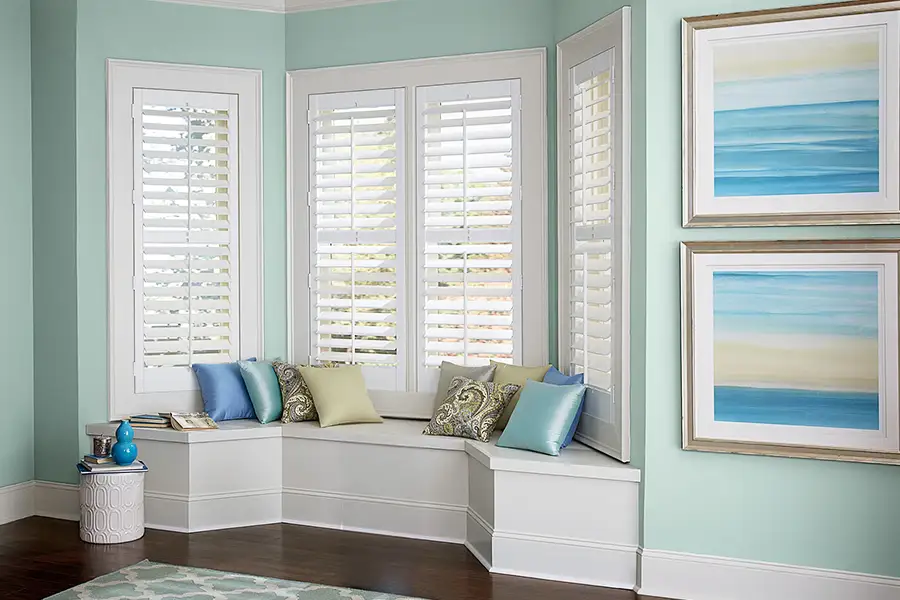 White Polywood Shutters on a bay window seat area