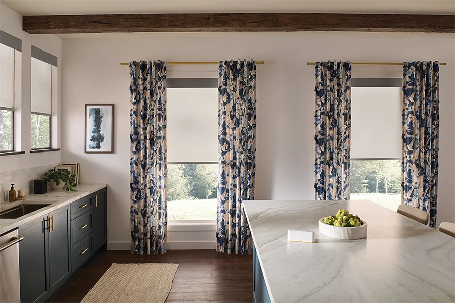 Blue and white patterned drapes on kitchen windows