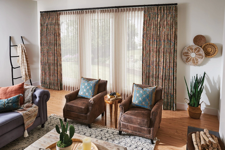 Drapes come in different opacities, from sheer to blackout, to give you control over light and energy efficiency. Opaque brown and white sheer drapes layered on a living room window