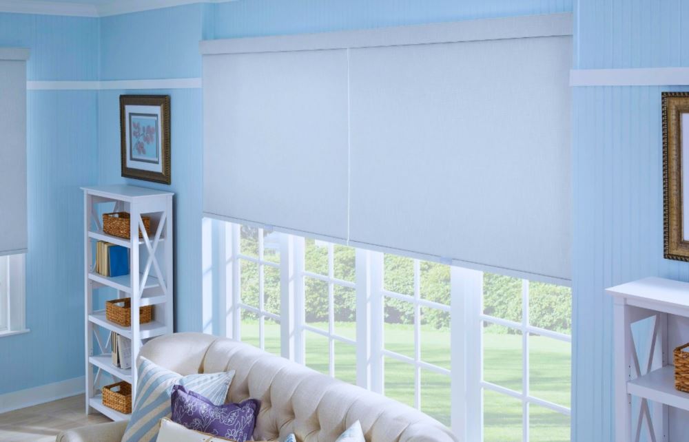 Put motorized window shades on hard-to-reach windows for easy operation! Large white roller shades on living room windows