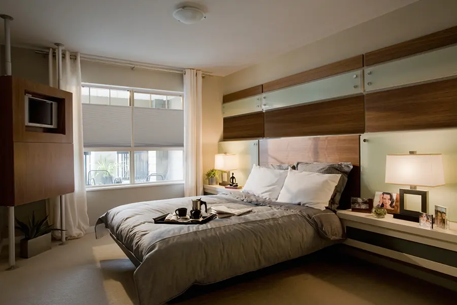 Top-down/bottom-up shades give you light and privacy in many different situations. Gray top-down/bottom-up shades on a bedroom window