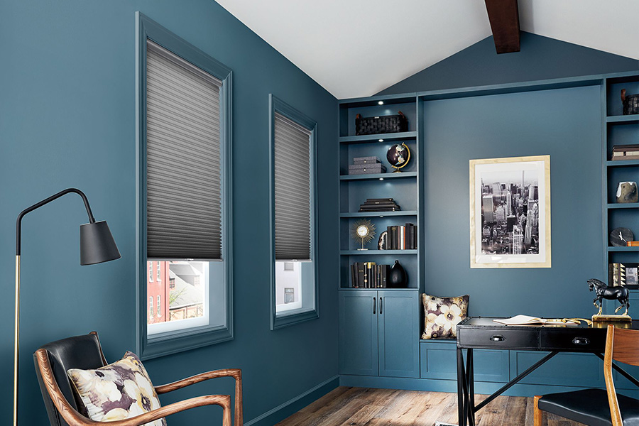 If you like softer window treatments, you'll appreciate the look and energy efficiency of cellular shades. Gray cellular window shades on home office windows