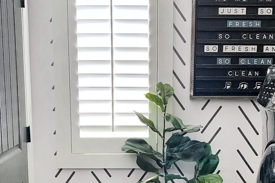 Elegant Polywood shutters lets in the sunshine in a mudroom. White polywood shutters in a mudroom