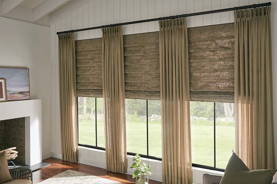 Matching Roman shades and curtains on living room windows