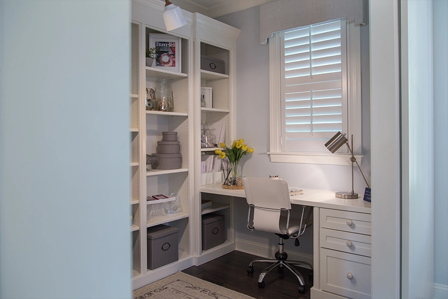Polwood shutters block the most heat and light of any blackout window treatment and fit on any window. White Polywood shutters on a home office window