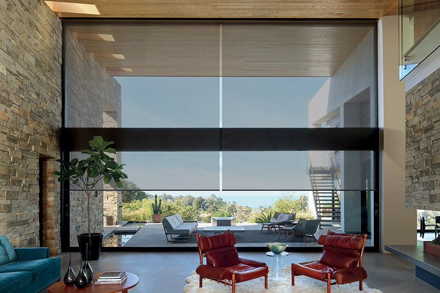 Sheer shades on oversized window of beach house