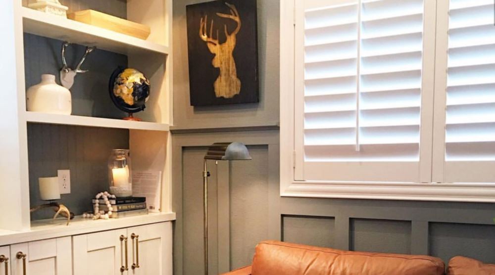 Window treatments provide a comfortable reading nook space in . Photo Credit: Kathy @ TheDailyNest Reading nook with white louvered shutters